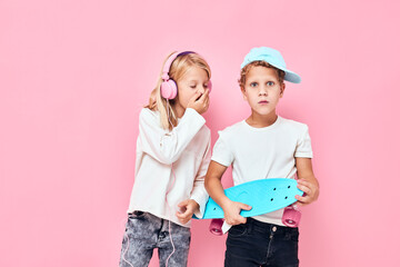 Stylish little boy and cute girl happy faces blue studio