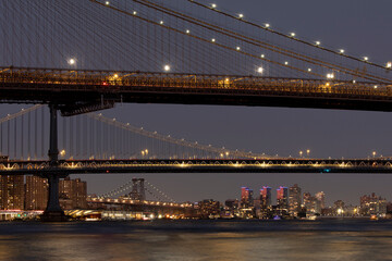 Brooklyn, Manhattan, and Williamsburg Bridges at dusk. 