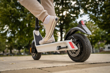 unknown man standing or driving electric kick scooter e-scooter © Miljan Živković