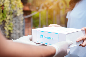 Closeup hands of women patient take covid first aid box self recover health care. customer delivery service from hospital online clinic retail Rx drug store in e-commerce home order.