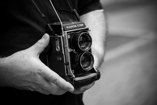 Strasbourg - France - 10 September 2022 - Closeup of retro mamiya camera in hands of man in the street