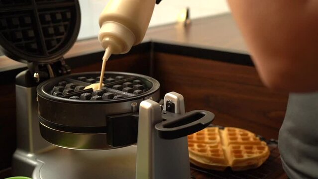 Putting adding dough in to gofrera waffle maker oster in slow motion