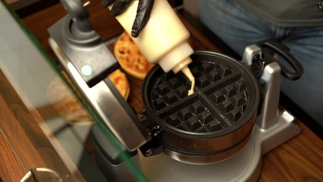 Top view of dough waffle maker oster gofrera in slow motion