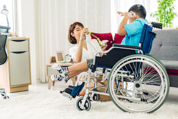 Portrait of enjoy happy love family asian mother playing and carer helping look at disabled son...