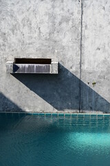 faucet of swimming pool on cement wall, construction industry