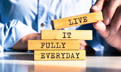 Wooden blocks with words 'Live It Fully Everyday'.