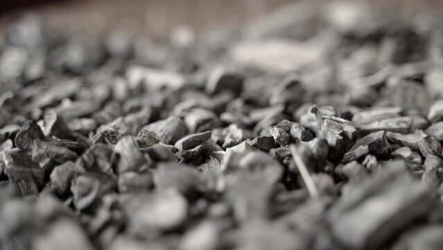 Fossil coal close-up, reserves. Smooth motion close-up over near hard coal in a warehouse. Raw materials for heating and electricity production. Unlimited use of the planet's resources
