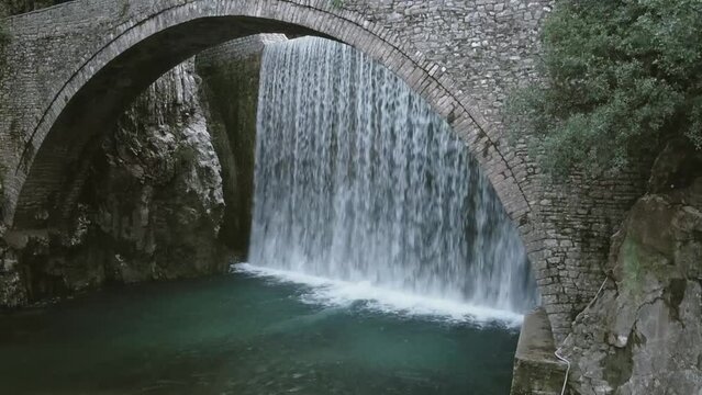 Waterfall and an old stoned bridge at a small village in Greece.
