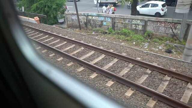 View on railroad track from the window of fast train. Bullet train rides on the railway track