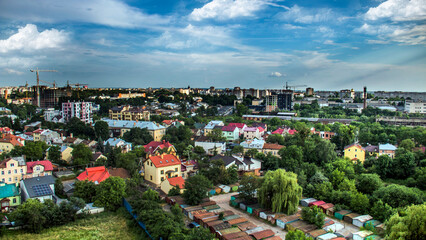 The city of Lviv from a height above the roofs of houses and green plants	
