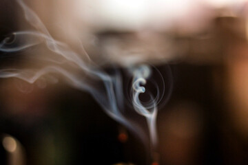 smoke in the form of the sign OM from incense