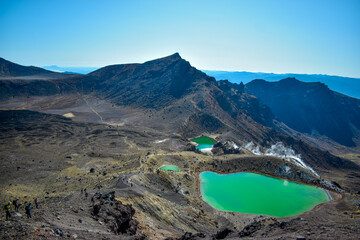 New Zealand, Emerald Lakes are located near the summit of Mt Tongariro. Their brilliant colours are partly caused by dissolved minerals, washed down from the thermal area of nearby Red Crater.