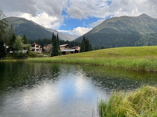 Fototapeta premium Alpine mountain lake Schwarzsee or Black Lake between the tourist towns of Davos and Klosters - Canton of Grisons, Switzerland (Kanton Graubünden, Schweiz)