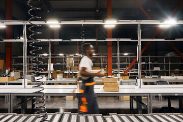 African factory worker delivering box at the storage