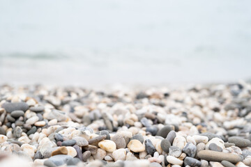 Pebbles on the beach. Black Sea. Beach with colorful rocks. Pebble by the sea. Background from stones. 