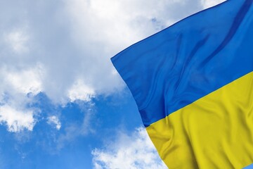 Colored national flag of Ukraine waving in the sky. Patriotism concept.