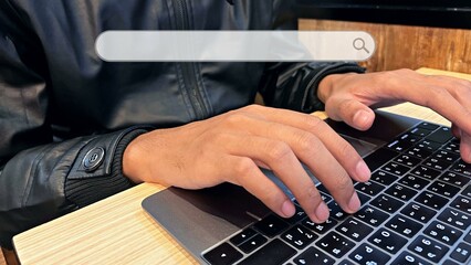 Hand of business executive using laptop at desk in office