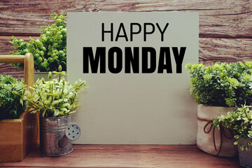 Happy Monday text message on wooden background