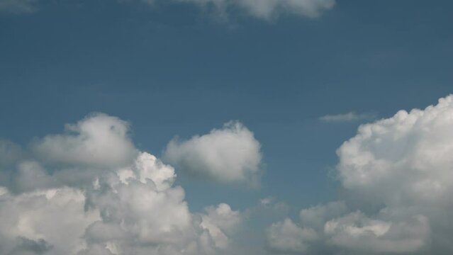Timelapse of cumulus clouds moving in the blue sky. Light clouds change their shape in cloud space. 