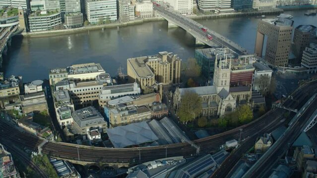 Pan up aerial from borough market to the city of London in London England
