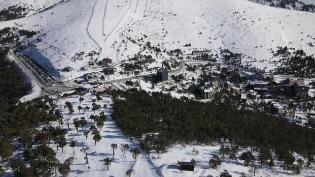 Beautiful aerial view of a ski resort covered in white snow in Navacerrada (Madrid), Spain
