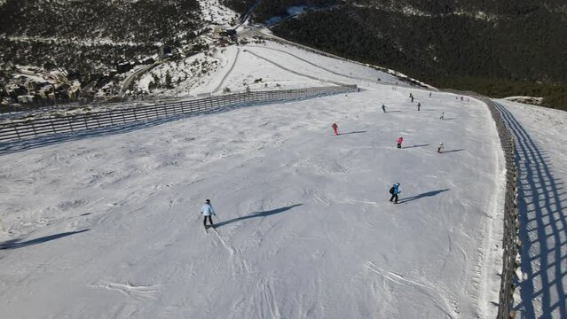People practice skiing in Navacerrada, Madrid, Spain, in the middle of a beautiful forest