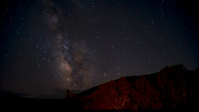 The core of the Milky Way crosses the sky above the Wasatch Front mountains in Utah - time lapse