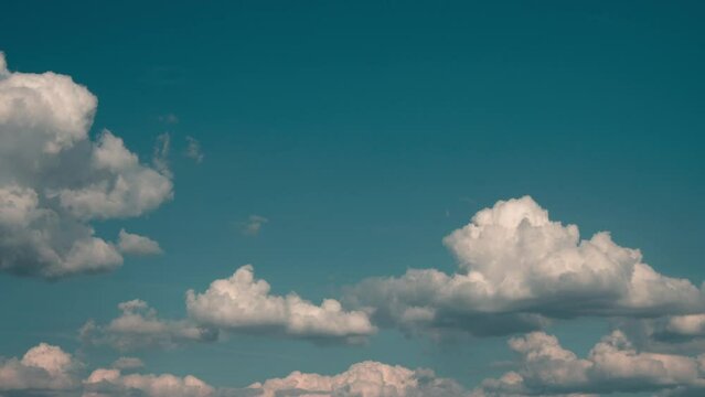 Timelapse of cumulus clouds moving in the blue sky. Light clouds change their shape in cloud space. 