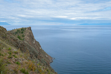 Beautiful summer landscape of Baikal Lake on sunny day. View of the rocky cape