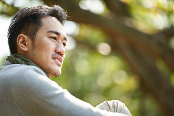 outdoor portrait of a young asian adult man