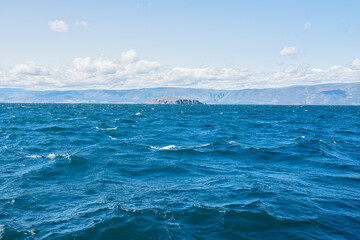 Clear fresh water and panorama of Lake Baikal on a summer day. 