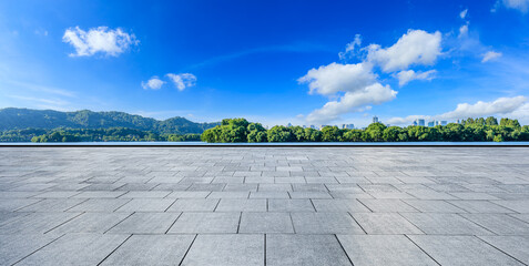 Empty city square and green mountain with modern city skyline in Hangzhou, China.