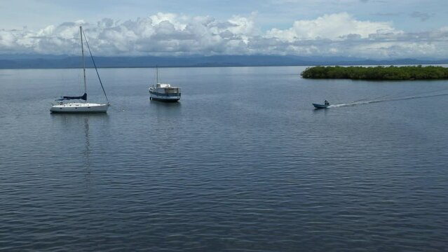 Static handheld shot of a small boat returning from a trip. Bocas del Toro, Panama