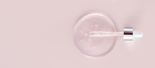 glass pipette serum gel closeup in petri dish on beige background	
