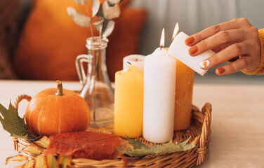Obraz na płótnie Canvas Autumn interior and festive mood with burning candles and pumpkin.