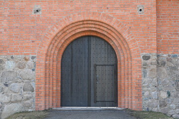 Fototapeta na wymiar Doors in a brick wall in an old building
