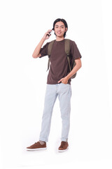 portrait of young man with backpack and using cell phone on white background