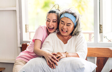 Portrait of enjoy happy love asian family senior mature mother and young woman daughter smiling laughing embracing and having fun hug together.happy family in moments good time at home