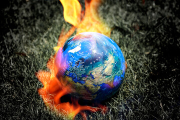 Fire globes on dry grass world healing concept Protect the world from global warming and preserve nature.