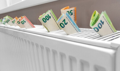 Euro money on the radiator. Heat and economy.