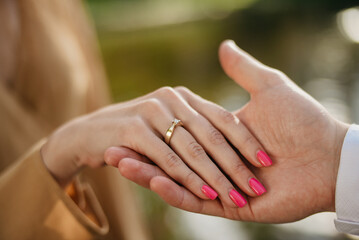 Declaration of love, offer of hand and heart. Wedding rings on hands