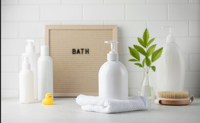 Fototapeta na wymiar Blank plastic dispenser bottles with soap and shampoo for everyday in bathroom. Toiletries set