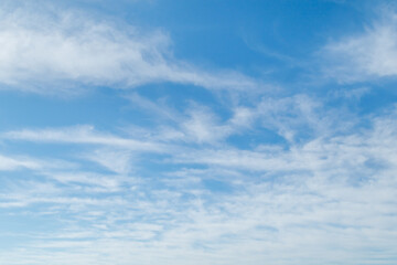 White fluffy clouds in the blue sky. Blue sky background and white clouds soft focus, pastel sky