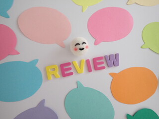 吹き出しの真ん中に笑顔とreviewレビューの単語、高評価のイメージ