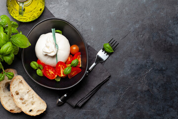 Burrata cheese, various tomatoes and olives