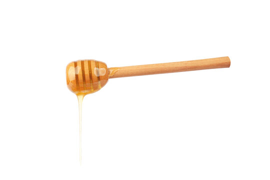 wooden spoon with honey on white background.