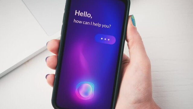 Woman using smart virtual assistant on her smartphone. AI voice assistant app for mobile phone.