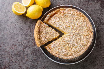 Fragrant cake tart with lemon curd and streusel close-up in a plate on the table. Horizontal top view from above