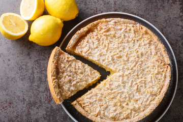 Grated cake Lemon curd pie close-up in a plate on the table. Horizontal top view from above