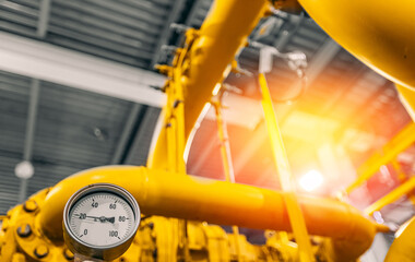 Pressure meters on natural gas yellow pipeline red valves. Concept industry power plant background